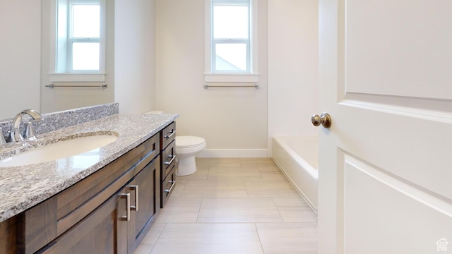 9270 N 5600 W Unit 7, Elwood, UT 84337 - full bathroom featuring toilet, baseboards, a wealth of natural light, and vanity