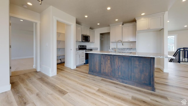 9270 N 5600 W Unit 7, Elwood, UT 84337 - kitchen with light wood-style floors, stainless steel appliances, a sink, and recessed lighting