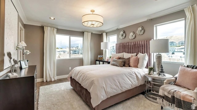 bedroom featuring ornamental molding and wood-type flooring