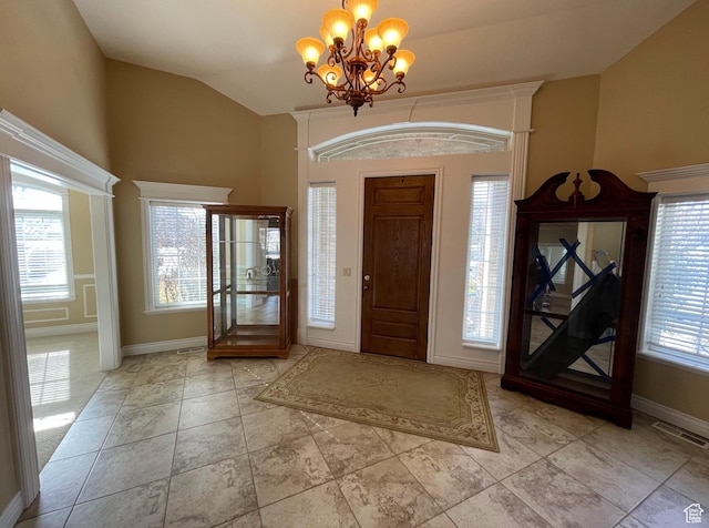 entrance foyer with a chandelier and vaulted ceiling
