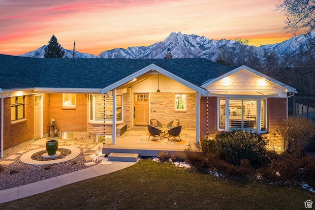view of front facade featuring a yard and a mountain view