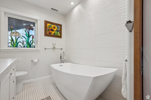 5419 S Kenwood Dr E, Salt Lake City, UT 84107 - bathroom featuring vanity, tile patterned floors, a freestanding tub, baseboards, and tile walls