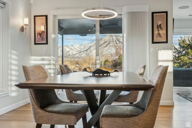 5419 S Kenwood Dr E, Salt Lake City, UT 84107 - dining area with light wood-style flooring, baseboards, and a mountain view