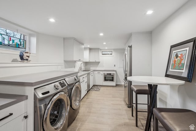 5419 S Kenwood Dr E, Salt Lake City, UT 84107 - laundry area featuring a sink, washer and clothes dryer, and recessed lighting