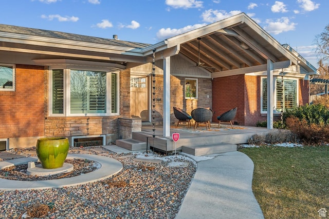 5419 S Kenwood Dr E, Salt Lake City, UT 84107 - property entrance with a porch, brick siding, stone siding, and a yard