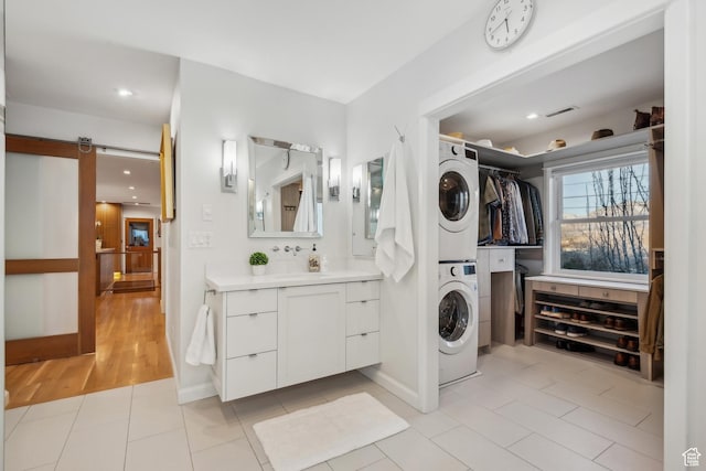 5419 S Kenwood Dr E, Salt Lake City, UT 84107 - full bath with stacked washer / drying machine, vanity, tile patterned floors, and recessed lighting