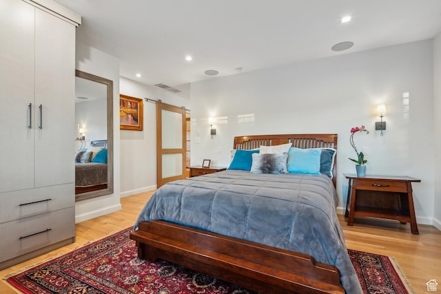 5419 S Kenwood Dr E, Salt Lake City, UT 84107 - bedroom with light wood-style floors, a barn door, baseboards, and recessed lighting