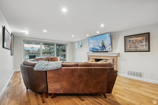 5419 S Kenwood Dr E, Salt Lake City, UT 84107 - living room featuring a fireplace, light wood-style flooring, recessed lighting, and baseboards