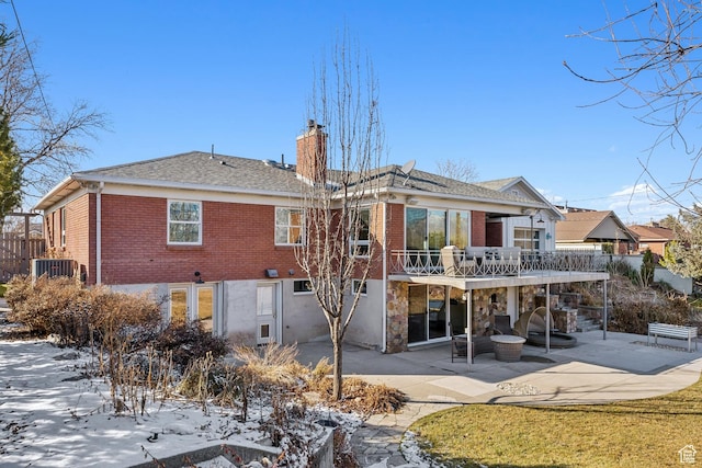 5419 S Kenwood Dr E, Salt Lake City, UT 84107 - rear view of property featuring brick siding, a patio area, a chimney, and roof with shingles