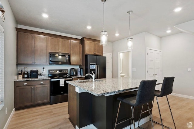 214 E Allegheny Pl S, Saratoga Springs, UT 84045 - kitchen with black appliances, a sink, light wood finished floors, baseboards, and a center island with sink