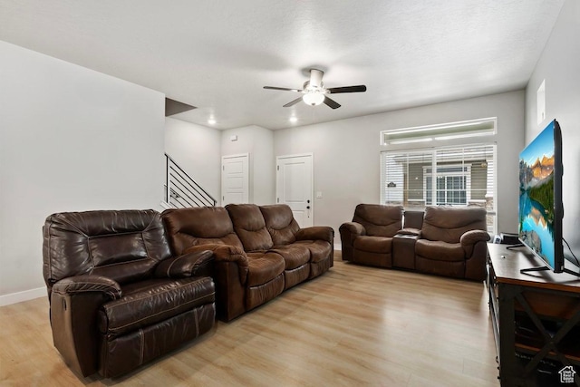214 E Allegheny Pl S, Saratoga Springs, UT 84045 - living room with light wood-style flooring, a ceiling fan, stairs, and baseboards