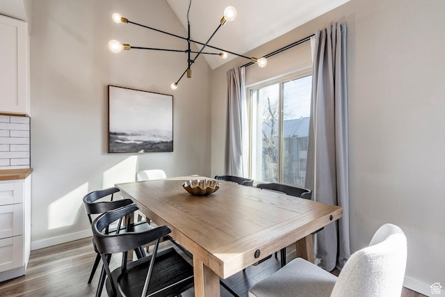 426 E Creekside Cir Unit E, Murray, UT 84107 - dining area with lofted ceiling, a chandelier, wood finished floors, and baseboards