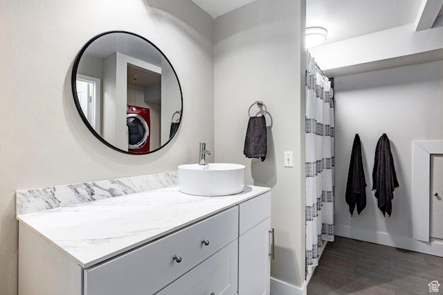 426 E Creekside Cir Unit E, Murray, UT 84107 - full bath with vanity, baseboards, wood finished floors, washer / dryer, and a shower with shower curtain
