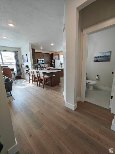 3469 S Bellrock Pl E Unit 5, South Salt Lake, UT 84115 - interior space featuring a textured ceiling and hardwood / wood-style floors