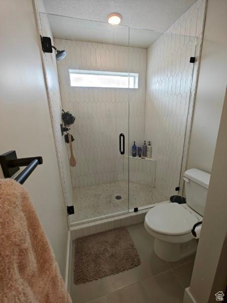 3469 S Bellrock Pl E Unit 5, South Salt Lake, UT 84115 - bathroom with toilet, walk in shower, and tile patterned flooring