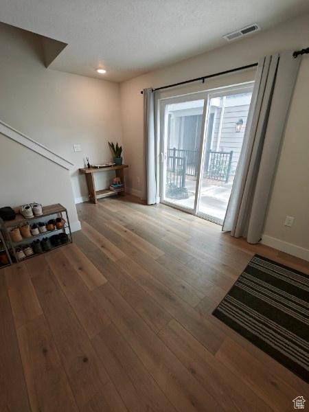 3469 S Bellrock Pl E Unit 5, South Salt Lake, UT 84115 - unfurnished living room with wood-type flooring