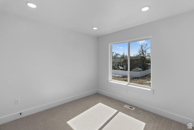 spare room featuring recessed lighting, visible vents, baseboards, and carpet