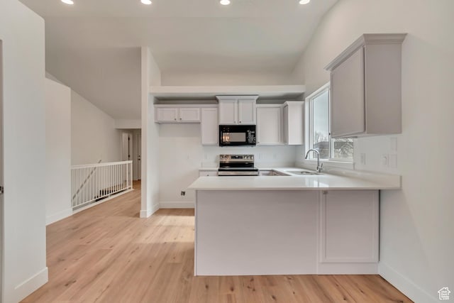 12972 S Cactus Berry Dr, Riverton, UT 84096 - kitchen with light countertops, light wood-style flooring, a sink, black microwave, and stainless steel electric range