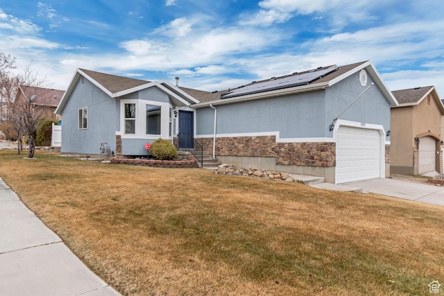 12972 S Cactus Berry Dr, Riverton, UT 84096 - ranch-style house featuring a garage, driveway, a front yard, roof mounted solar panels, and stucco siding