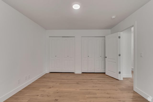 12972 S Cactus Berry Dr, Riverton, UT 84096 - unfurnished bedroom with light wood-type flooring, baseboards, and two closets