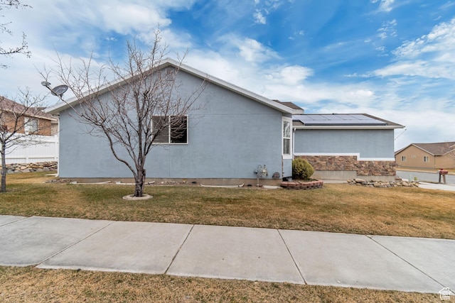 12972 S Cactus Berry Dr, Riverton, UT 84096 - view of front of house featuring a front yard, stone siding, a standing seam roof, roof mounted solar panels, and stucco siding