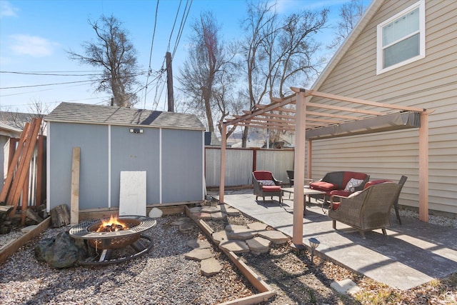 view of patio with a fenced backyard, a storage shed, an outdoor structure, a pergola, and an outdoor living space with a fire pit