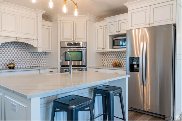 1105 S 500 W, Vernal, UT 84078 - kitchen with white cabinetry, appliances with stainless steel finishes, hanging light fixtures, and light stone counters