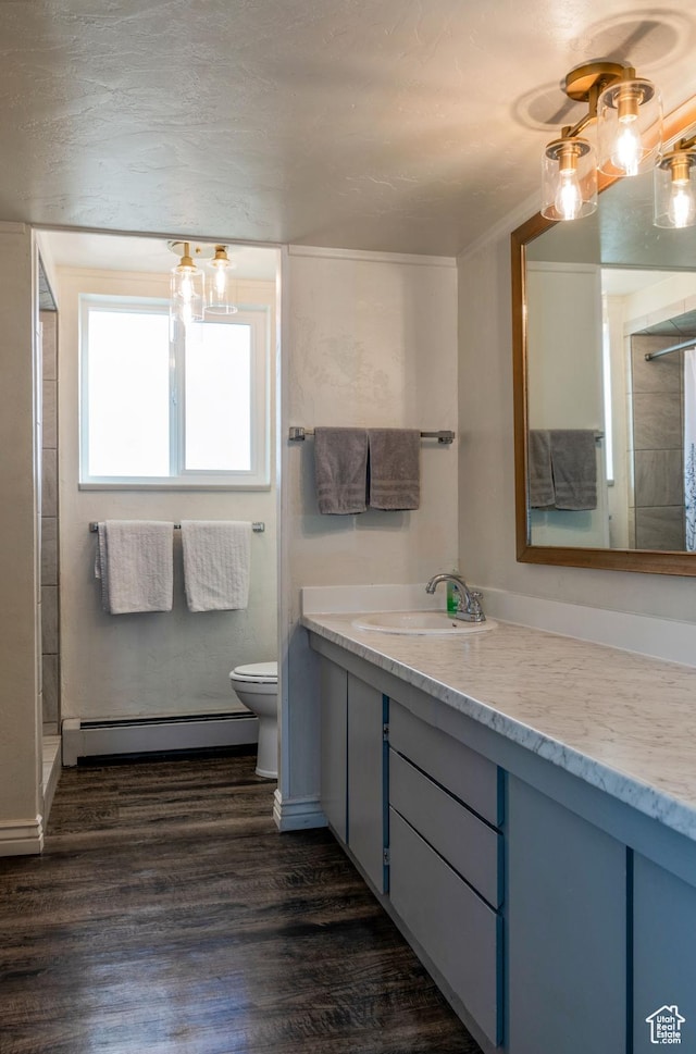 1105 S 500 W, Vernal, UT 84078 - bathroom featuring vanity, walk in shower, toilet, hardwood / wood-style flooring, and baseboard heating