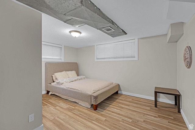 4868 S Ridgeline Dr, Washington Terrace, UT 84405 - bedroom with light wood-type flooring and a textured ceiling