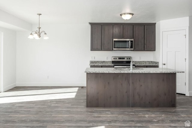 1152 W High Plains Dr Unit 612, Grantsville, UT 84029 - kitchen featuring wood finished floors, dark brown cabinets, a notable chandelier, and stainless steel appliances