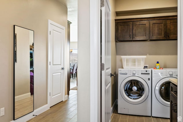 334 N 2020 W, Hurricane, UT 84737 - laundry room featuring washing machine and dryer, cabinets, and light hardwood / wood-style flooring