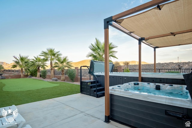 334 N 2020 W, Hurricane, UT 84737 - patio terrace at dusk featuring a mountain view and a hot tub