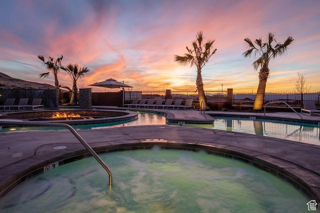 334 N 2020 W, Hurricane, UT 84737 - pool at dusk featuring a hot tub