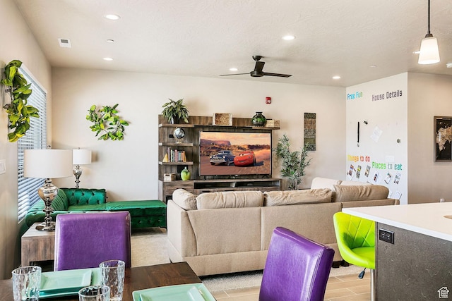 334 N 2020 W, Hurricane, UT 84737 - living room featuring light wood-type flooring, a textured ceiling, and ceiling fan
