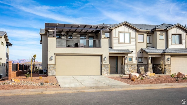 view of front of house featuring cooling unit, a garage, a mountain view, and a balcony