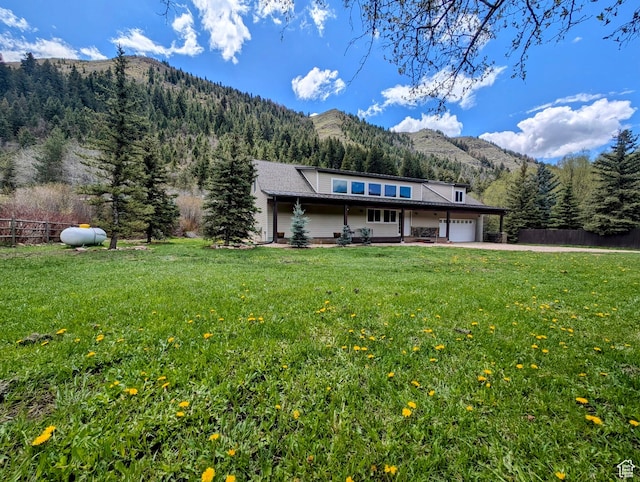 2326 Country Rd, Kamas, UT 84036 - view of front of house featuring a mountain view, a garage, driveway, and a forest view