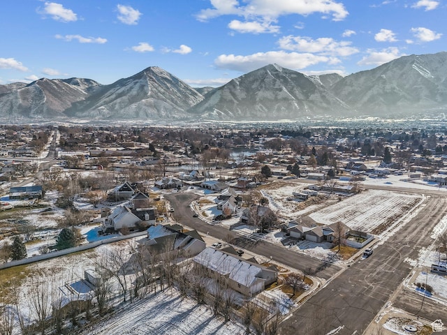 snowy aerial view with a mountain view