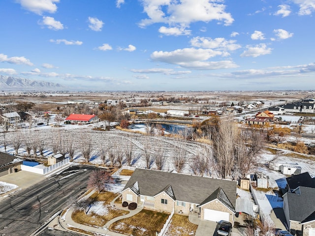 snowy aerial view with a mountain view