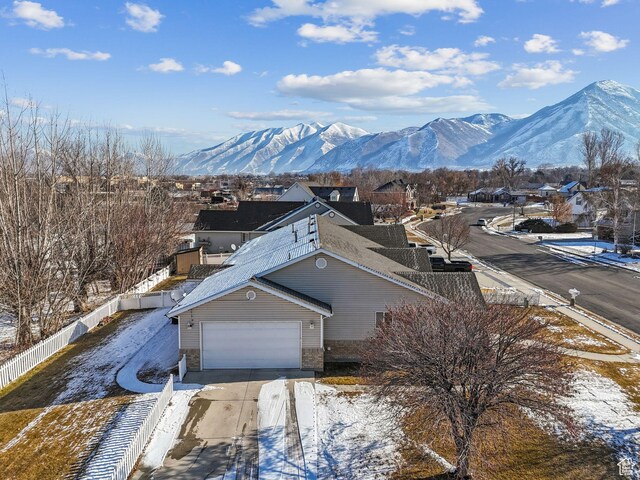 view of front facade with a garage and a mountain view