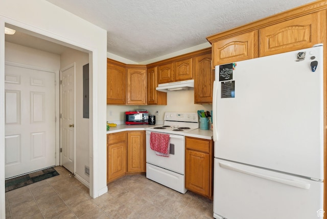 kitchen with a textured ceiling and white appliances