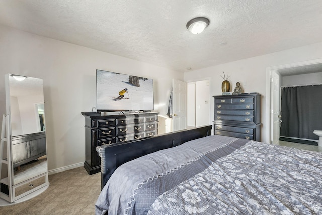 bedroom featuring a textured ceiling and light colored carpet