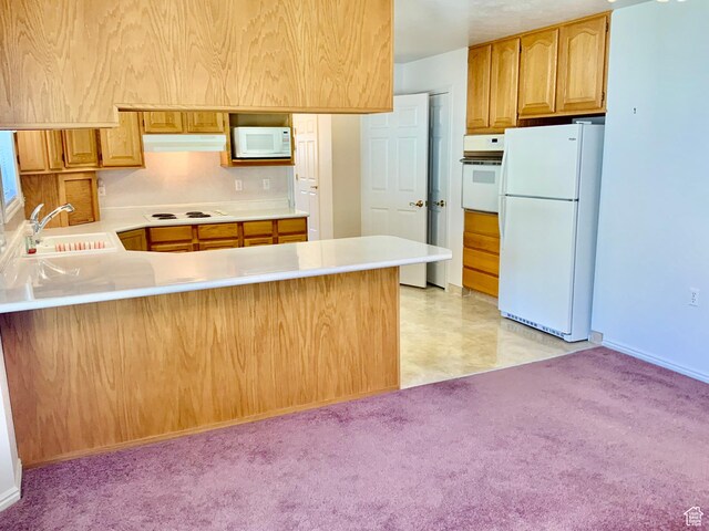 kitchen with sink, kitchen peninsula, white appliances, and light carpet