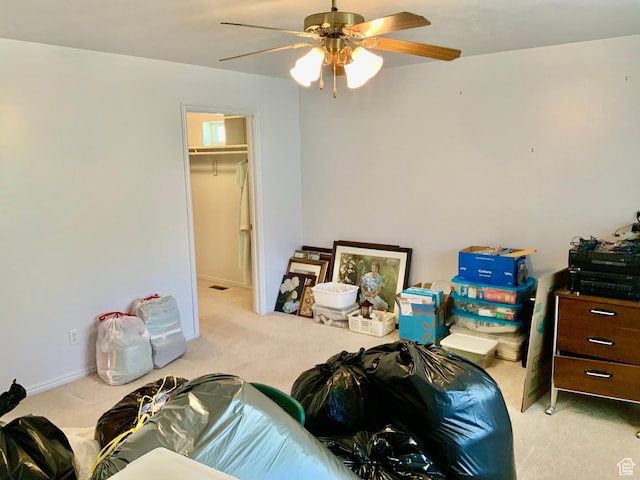 interior space featuring ceiling fan and light colored carpet