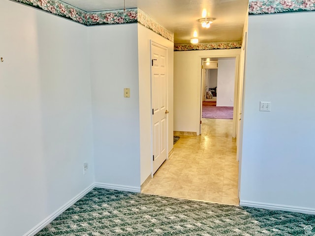 hall with light colored carpet