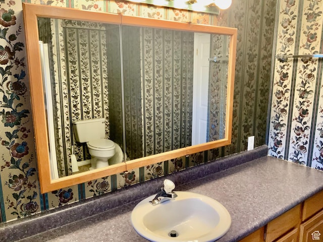bathroom featuring vanity and toilet