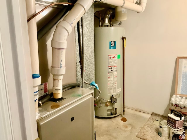 utility room featuring water heater