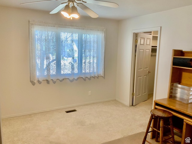 interior space with ceiling fan