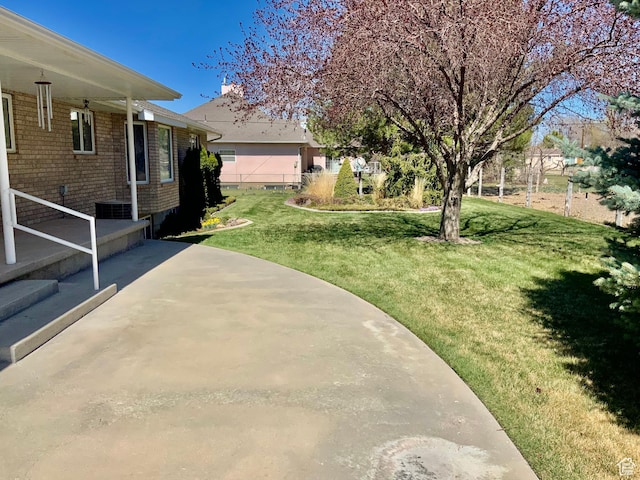 view of yard featuring cooling unit and a patio area