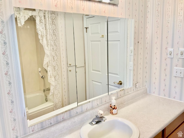 bathroom featuring shower / tub combination and vanity