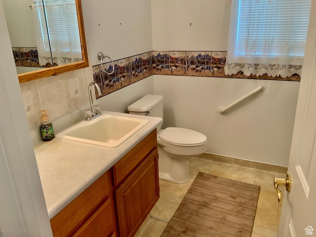 bathroom with vanity, tile patterned flooring, and toilet